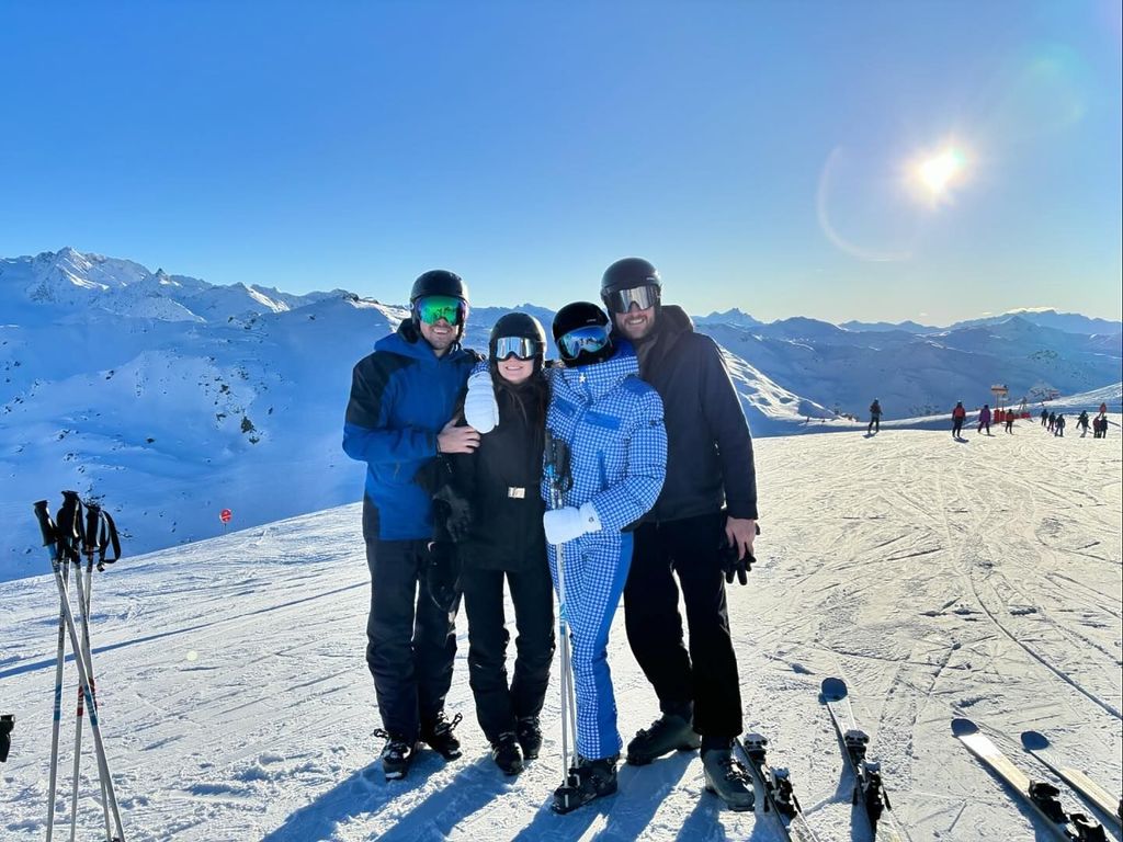 Sophie Turner in blue gingham snowsuit posing on the slopes with Peregrine Pearson 