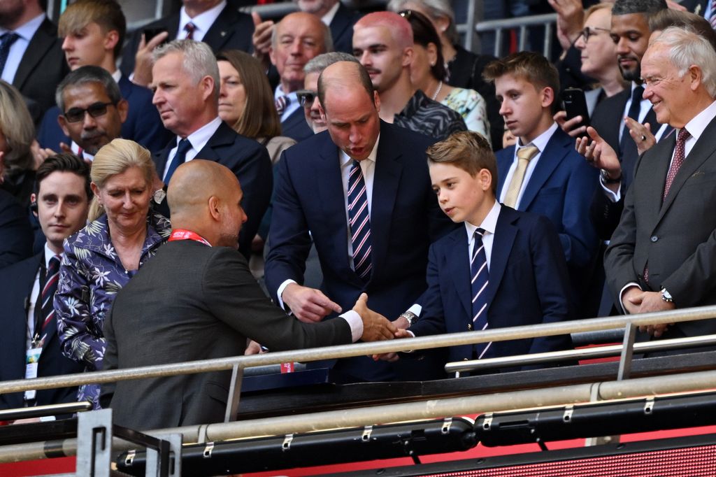 Prince George of Wales, shakes hands with Pep Guardiola
