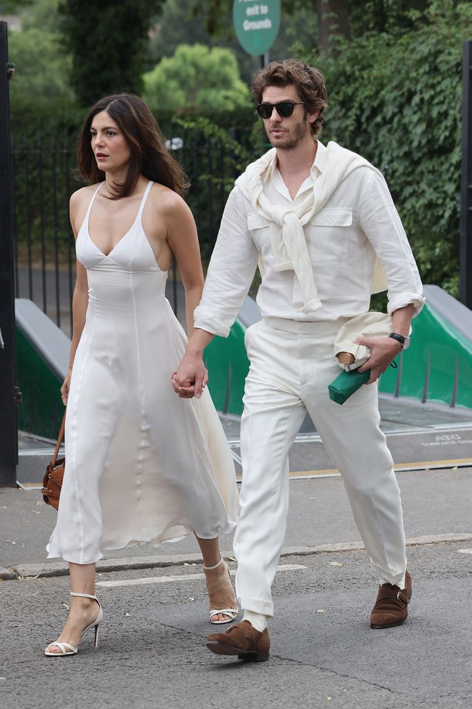 Monica Barbaro and Andrew Garfield arrive at All England Lawn Tennis and Croquet Club on July 06, 2025 in London, England