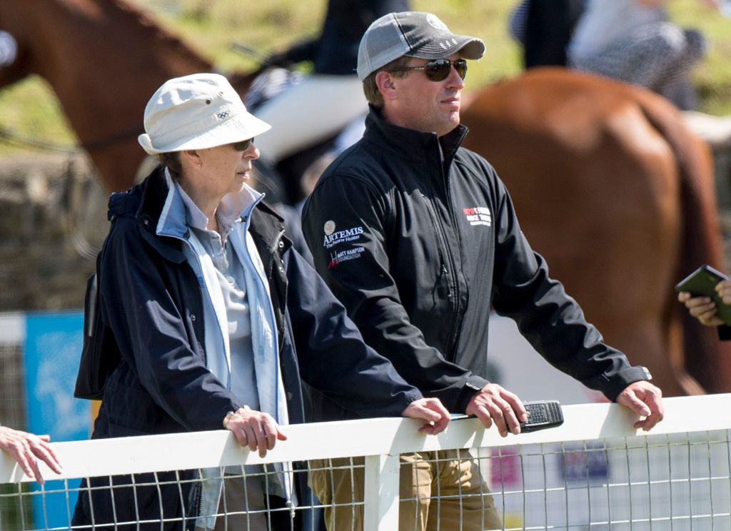 Princess Anne and Peter Phillips with a horse behind them