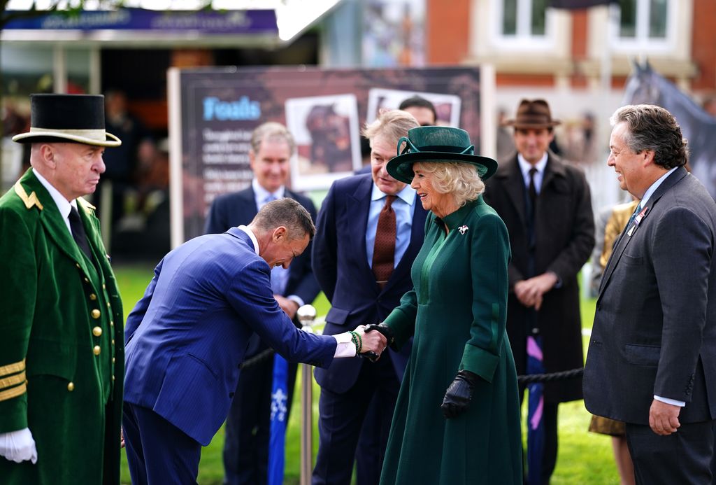 Queen Camilla shaking hands with Frankie Dettori