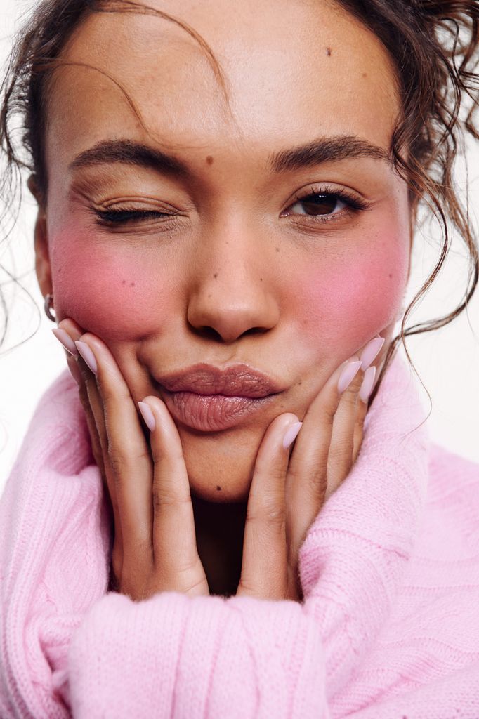 Glossier lifestyle imagery woman with bright blush 