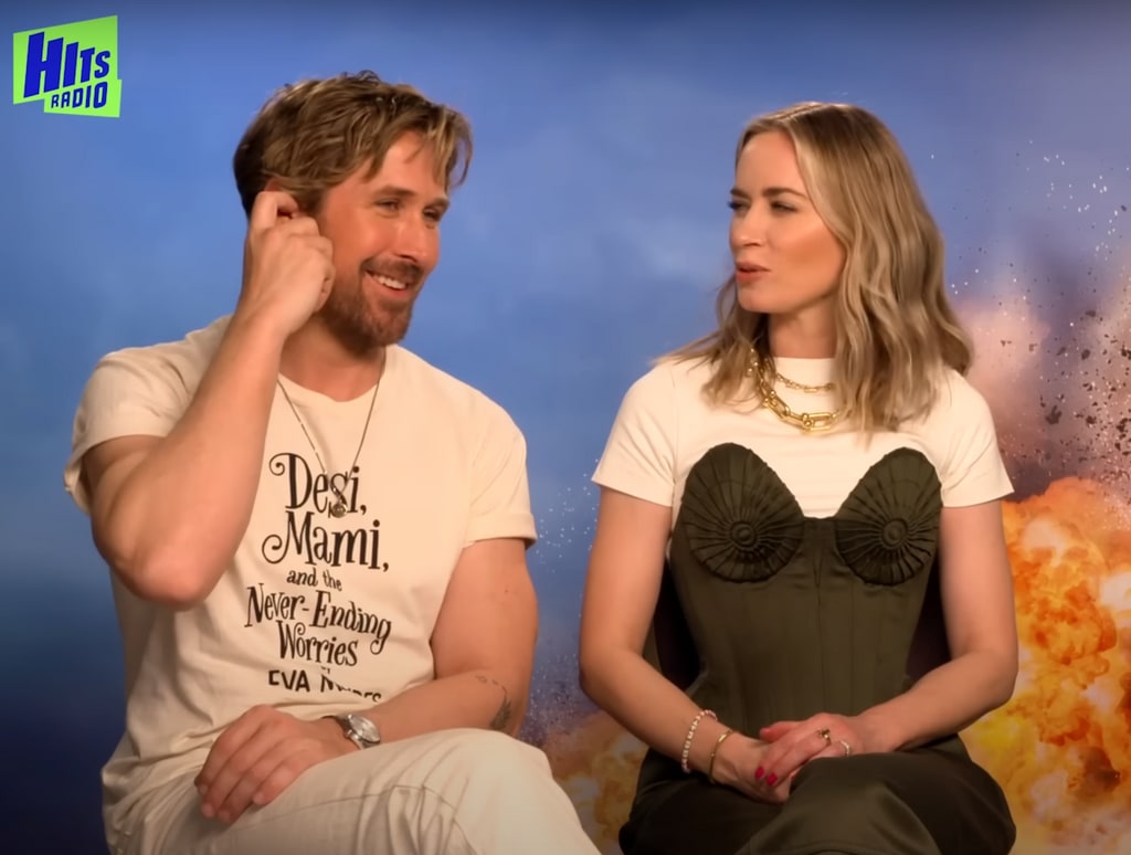 Photo from a video shared by Hits Radio to YouTube from an interview with Ryan Gosling and Emily Blunt, in which he's wearing a t-shirt that reads "Desi, Mami, and the Never-Ending Worries," Eva Mendes' upcoming children's book.