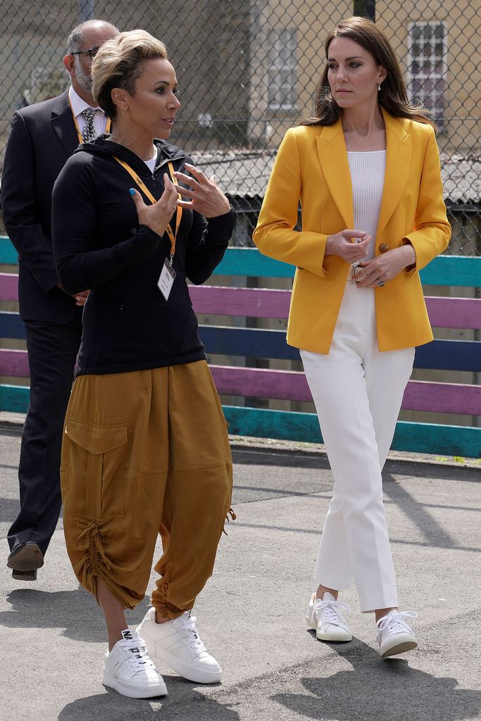 The Princess of Wales talks with Kelly Holmes as she visits the Dame Kelly Holmes Trust in Bath. She opted for a yellow LK Bennett blazer.