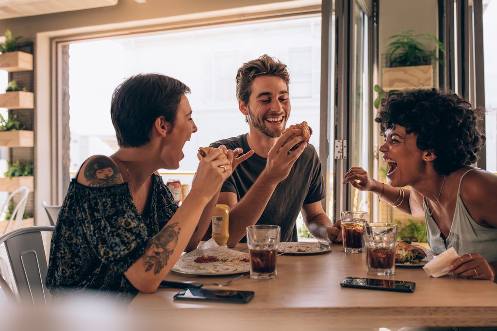 Group of friends laughing and having dinner