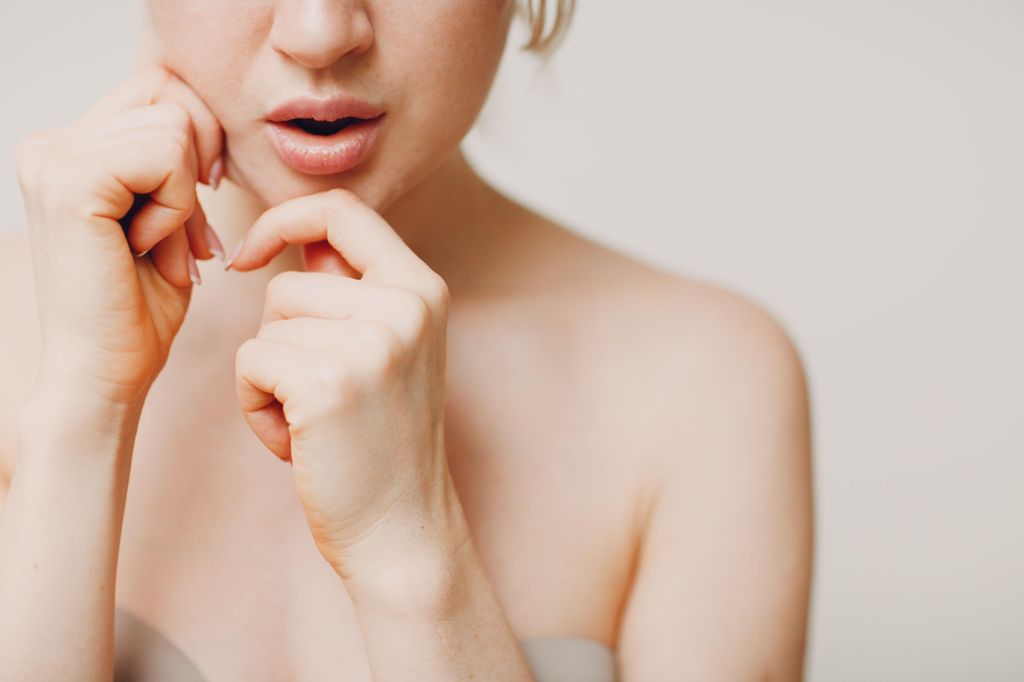 Young adult doing facial gymnastics self massage