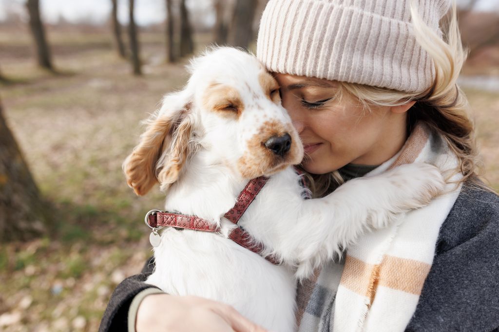 woman cuddling her dog