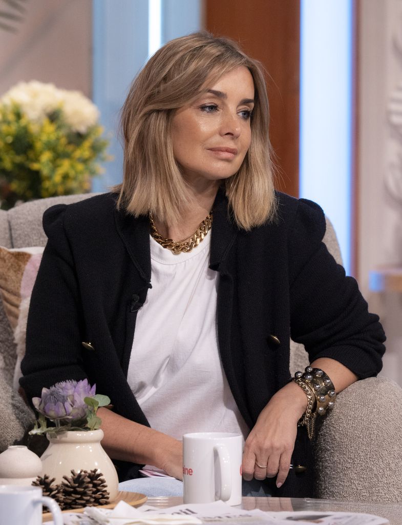 Louise Redknapp looking sad in a black blazer and white shirt
