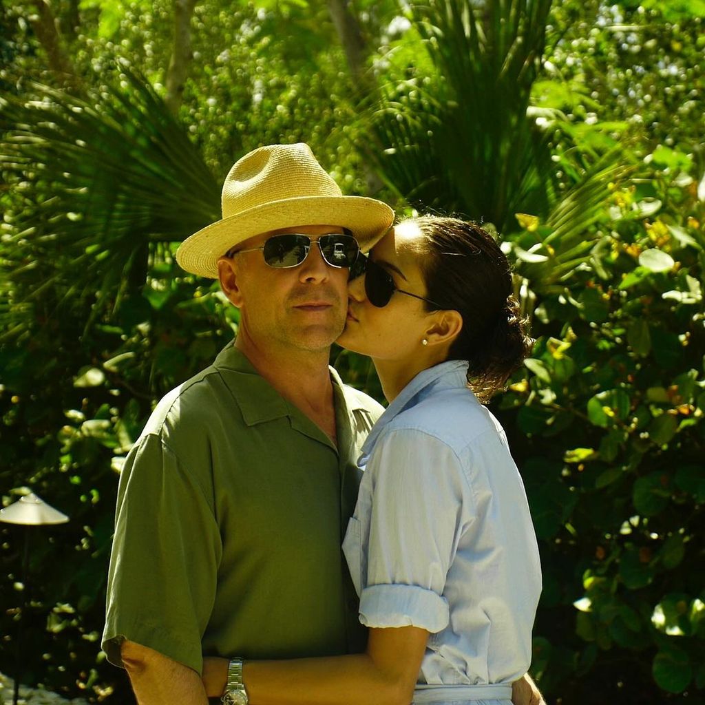 Emma kisses Bruce on the cheek as they celebrate their 16th anniversary