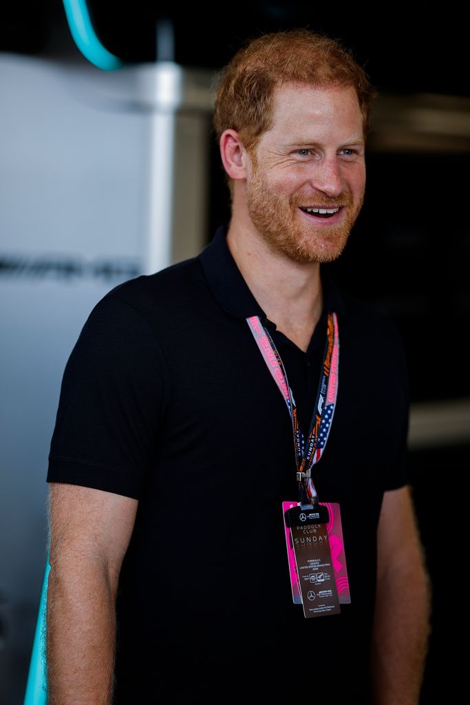 Prince Harry, Duke of Sussex looks on smiling in the Mercedes garage prior to the F1 Grand Prix 