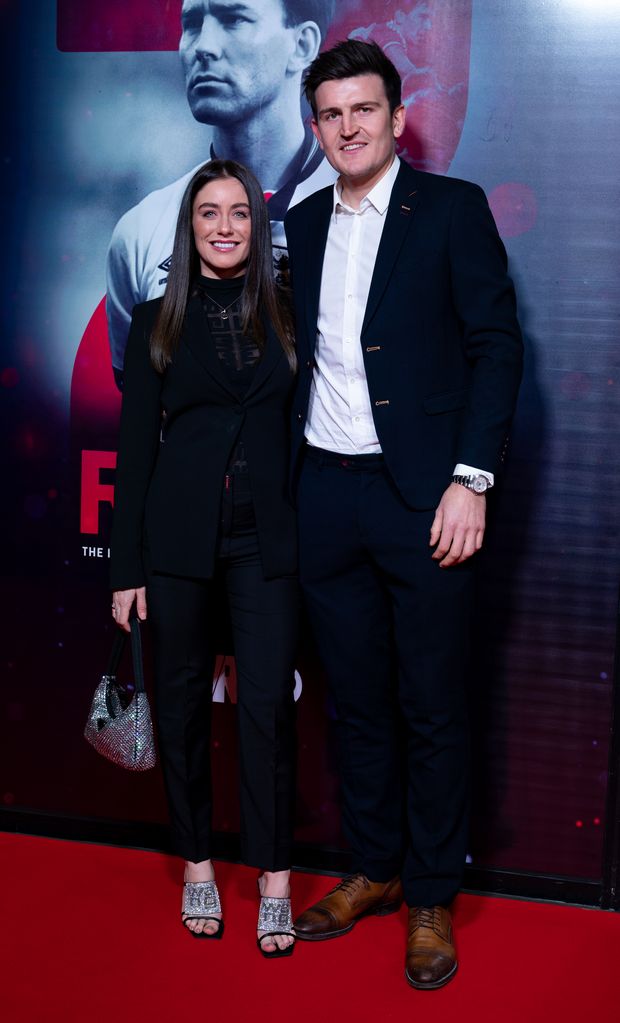 Harry Maguire in a suit with his wife Fern Hawkins dressed in black