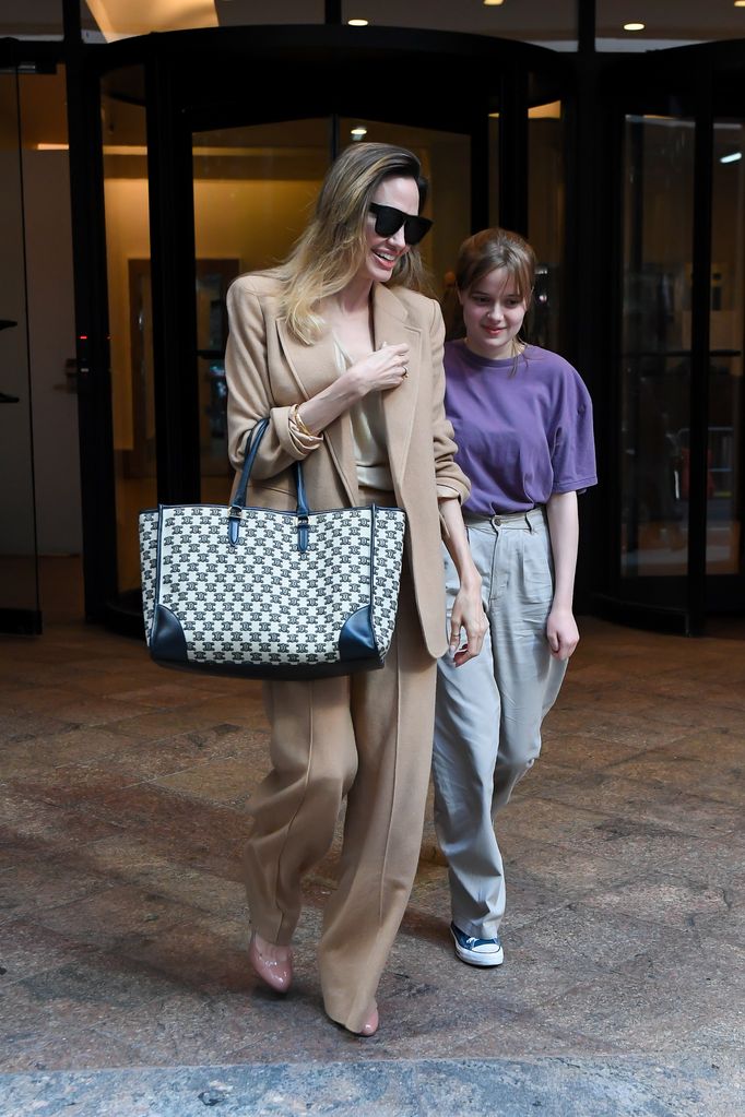 She also paired it with a camel suit for a day out with her daughter Vivienne