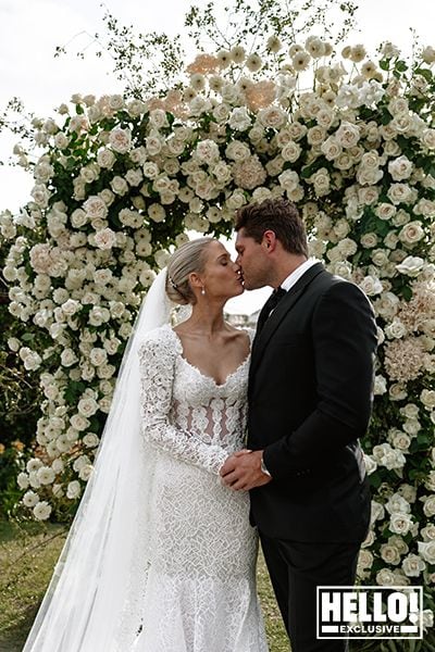 Lady Amelia Spencer kisses her new husband Greg Mallett under rose arch in South Africa