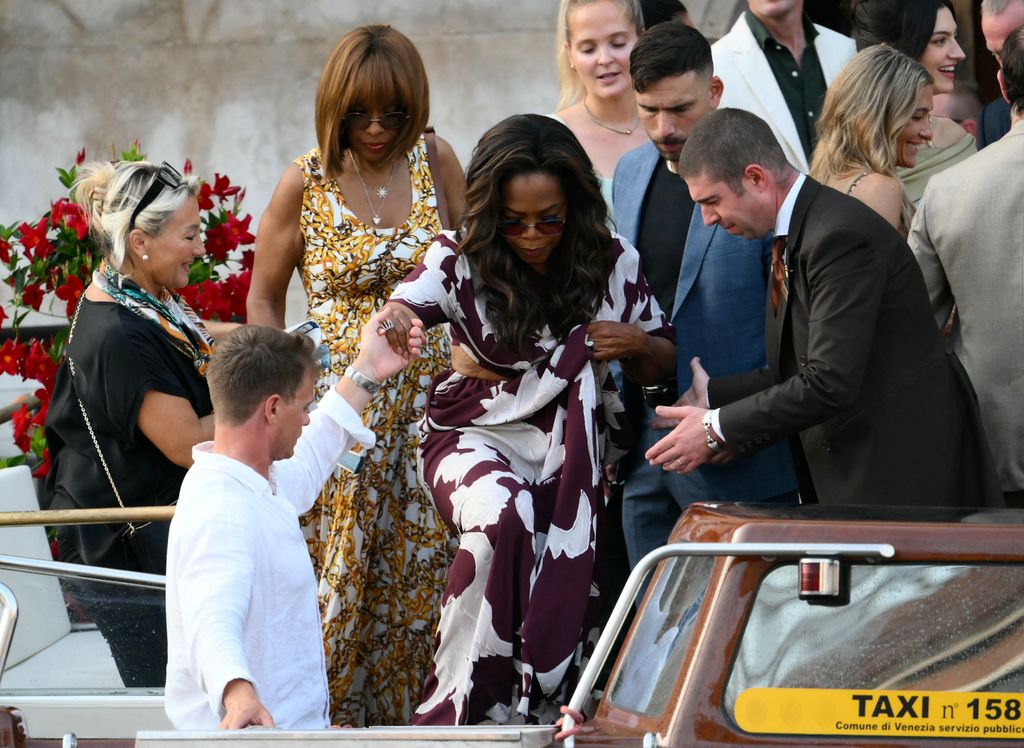 Gayle King (L) and US talk show host Oprah Winfrey get on a taxi boat as they leave the Gritti Palace Hotel ahead of the wedding of Amazon's founder Jeff Bezos with Lauren Sanchez in Venice on June 26, 2026
