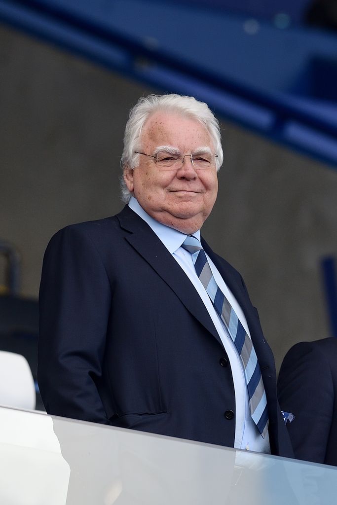 Bill Kenwright in a suit at a football match