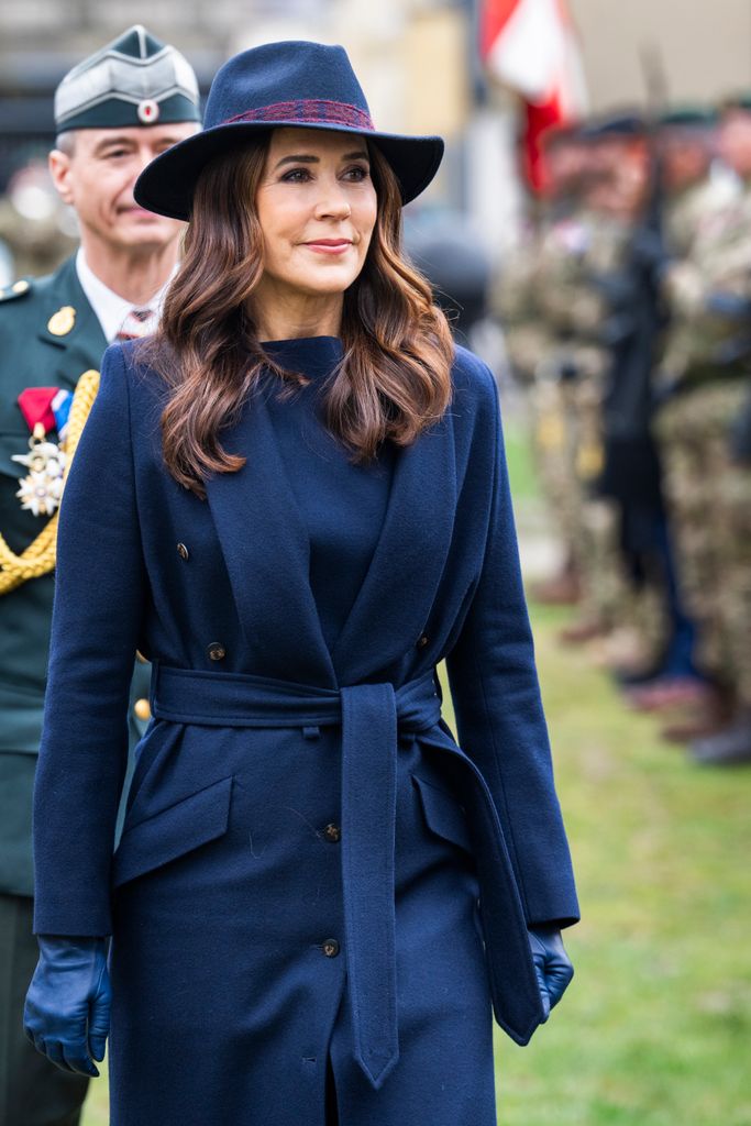 Queen Mary wearing navy coat and hat