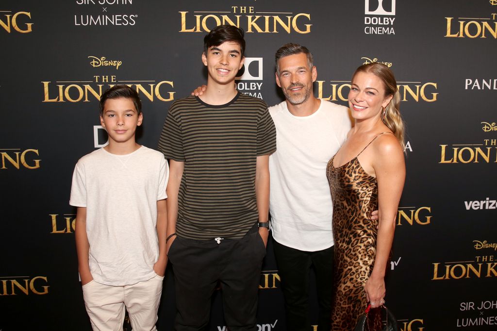  Jake Austin Cibrian, Mason Edward Cibrian, Eddie Cibrian, and LeAnn Rimes  against lion king backdrop