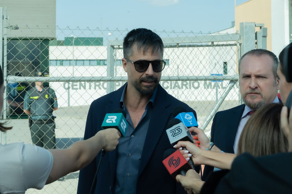 man talking into microphones