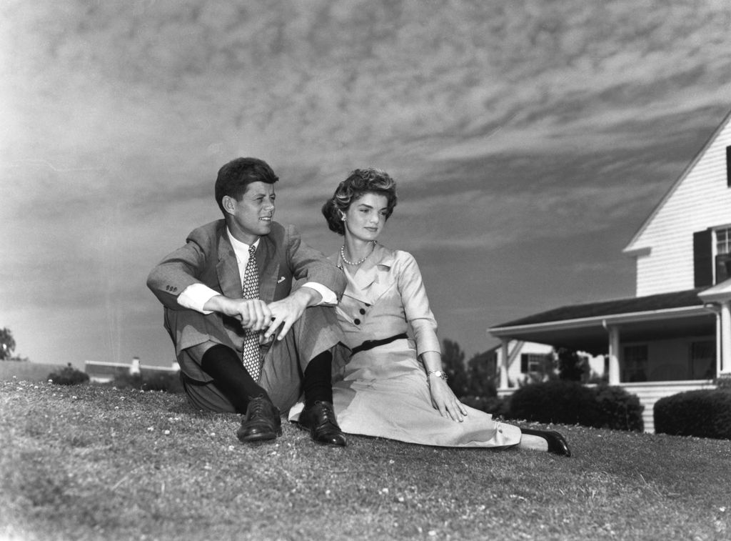 (Original Caption) 9/10/1953- Hyannisport, MA: Senator John F. Kennedy (D-MA) and Miss Jaqueline Bouvier of Newport, RI, will be married September 12 at Newport, in one of the most elaborate weddings of the current season. The couple are shown above at the Kennedy's Hyannisport, MA home shortly after their engagement was annouced. The stylish coupld is shown sitting together on the lawn of the estate.