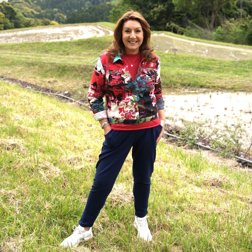 jane mcdonald wearing trousers and red jacket 