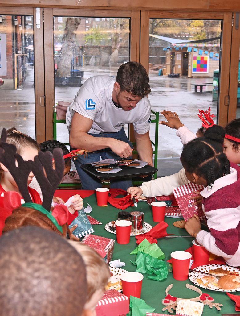 Will Poulter with children at Surrey Square Primary School 



