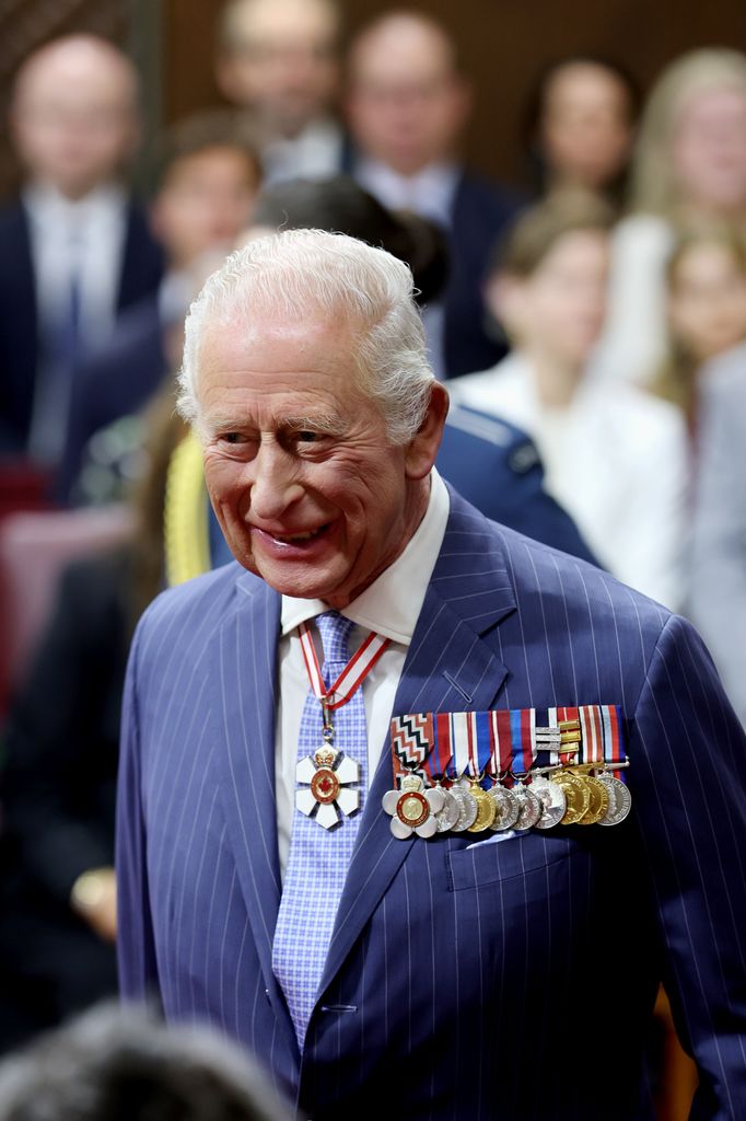 King Charles smiling wearing medals in Senate