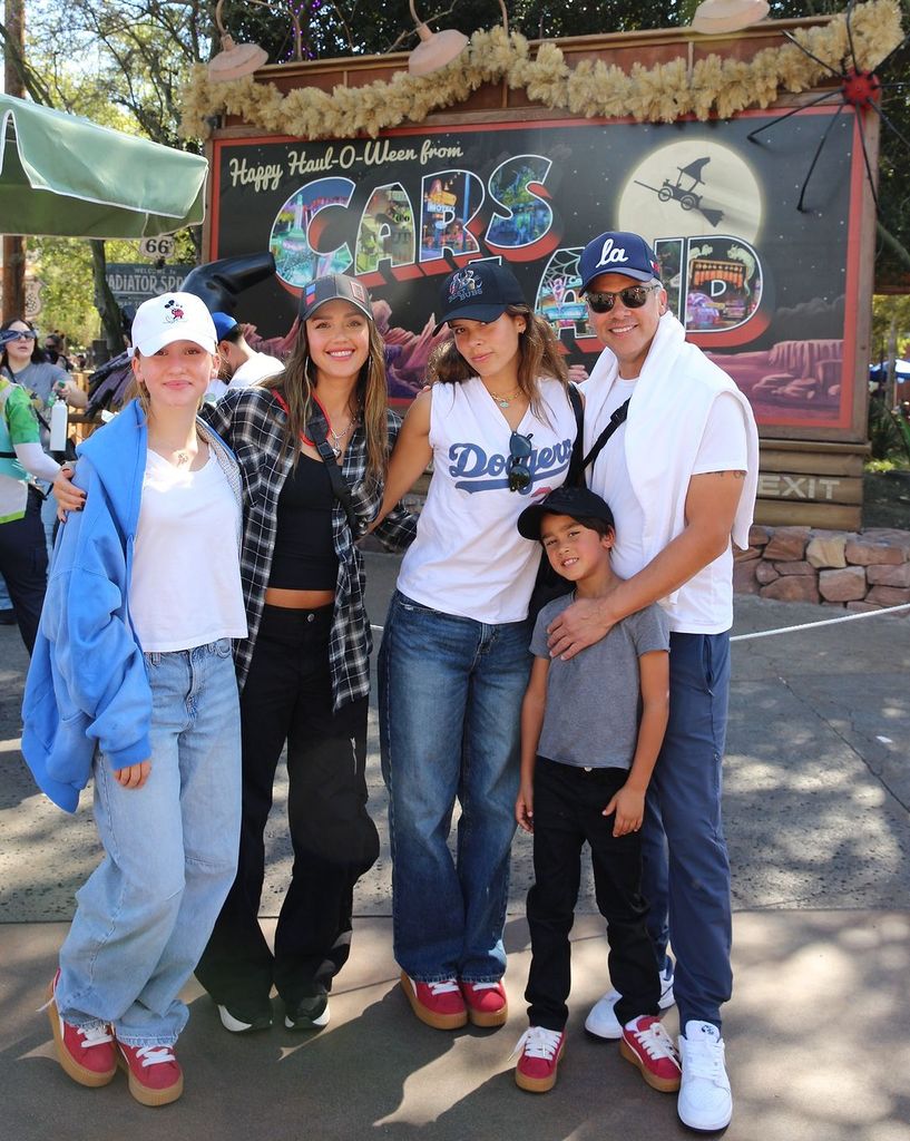 Haven, Jessica Alba, Honor, Cash Warren and Hayes stand in front of sign for Cars Land at Disney