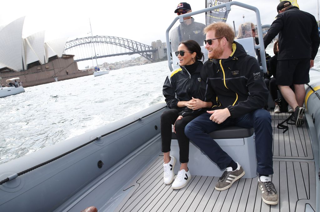 Prince Harry, Duke of Sussex and Meghan, Duchess of Sussex sail across Sydney harbour at Sydney Olympic Park on October 21, 2018 in Sydney, Australia.