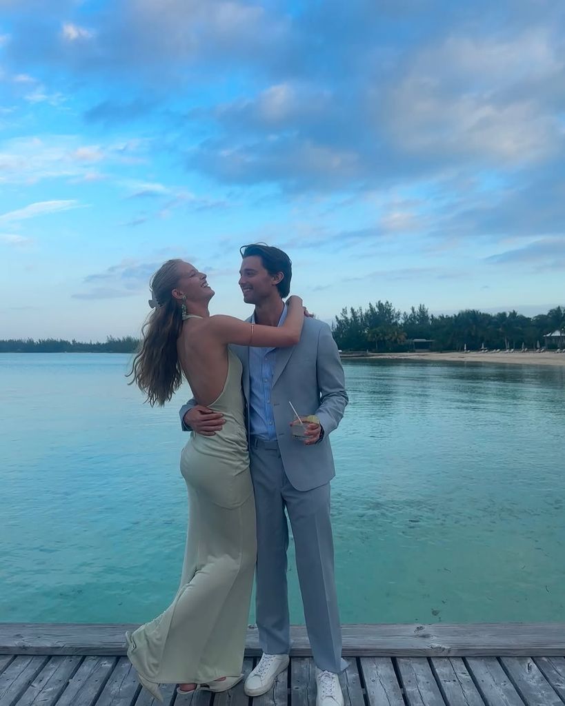 Abby Champion and Patrick Schwarzenegger hugging on a jetty in the ocean in vacation snap