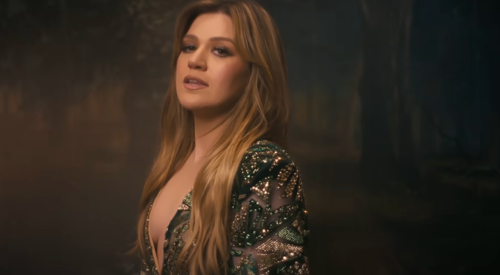 Kelly looked sultry in glittery catsuit with plunging neckline