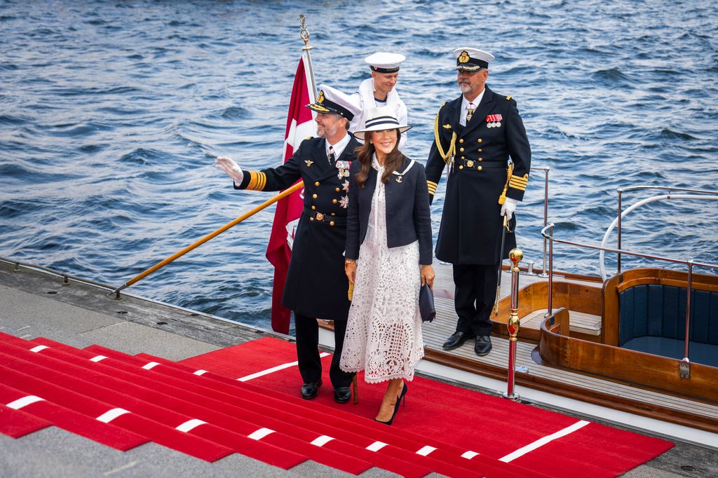 King Frederik X of Denmark and Queen Mary of Denmark on steps by sea