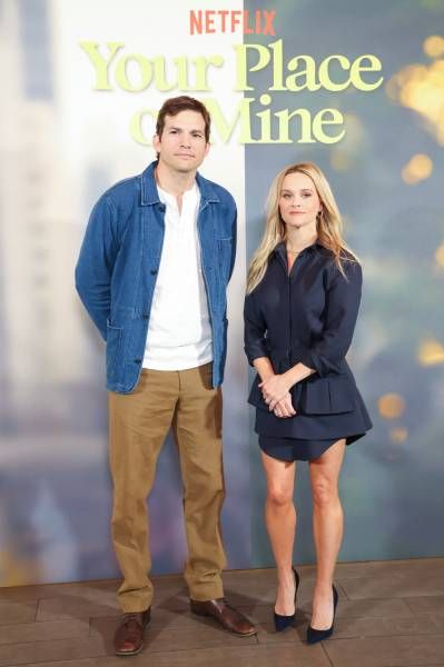 Reese Witherspoon and Ashton Kutcher awkwardly pose at a Your Place or Mine event red carpet