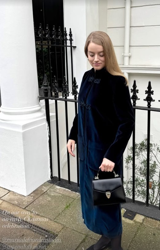 Flora Vesterberg standing in front of a white terraced house