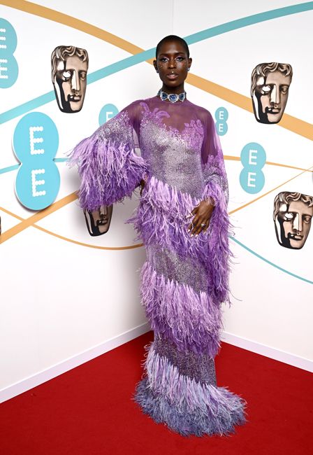 jodie turner smith looks amazing in purple feather embellished dress on baftas red carpet