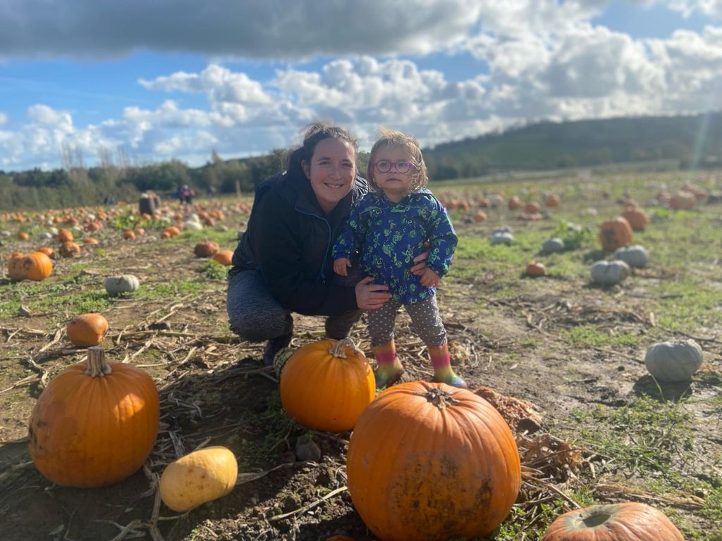 Willow in pumpkin patch with her her mum