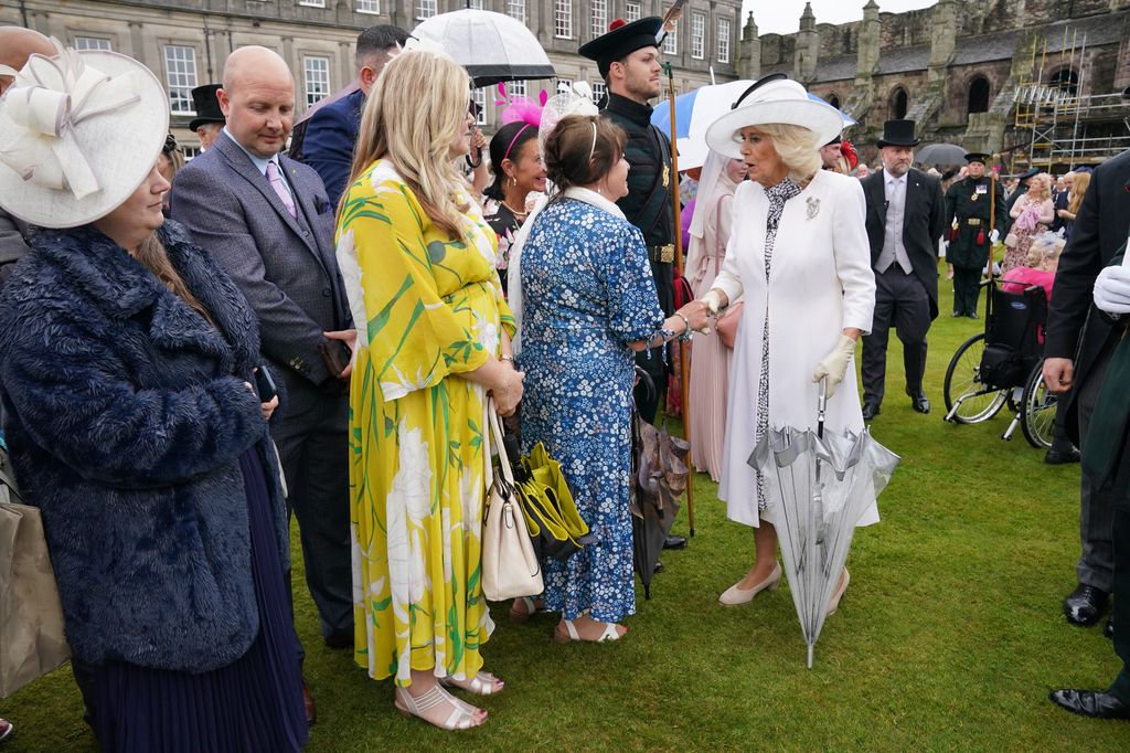 Queen Camilla greets guests during a Garden Party at the Palace of Holyroodhouse