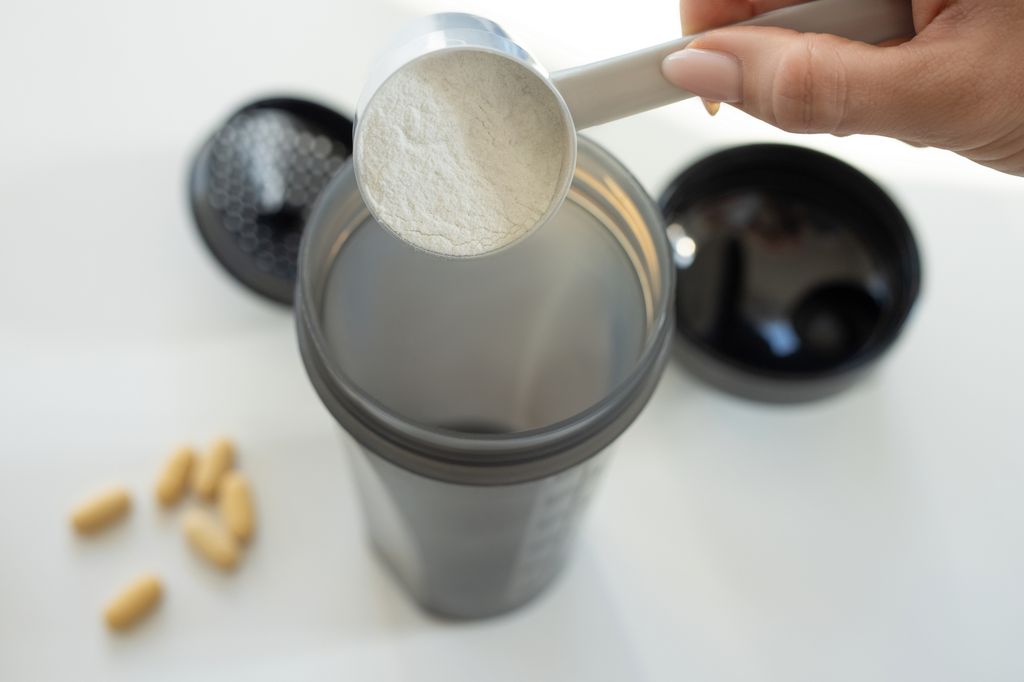supplement in powder form being poured into bottle