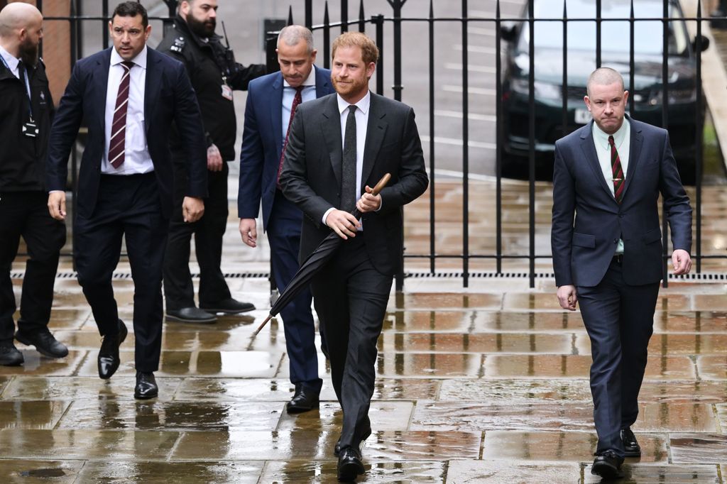 Prince Harry in a grey suit arriving at court