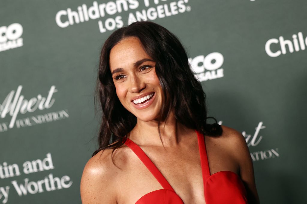 woman smiling in red dress at gala