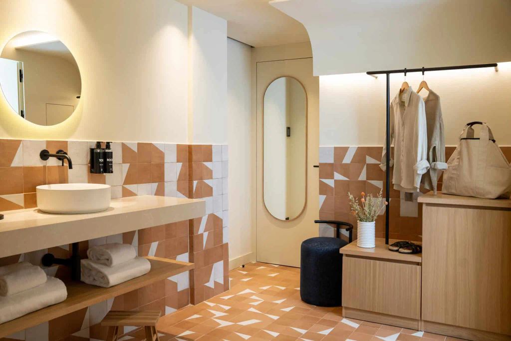 open plan hotel room with sink and wardrobe 