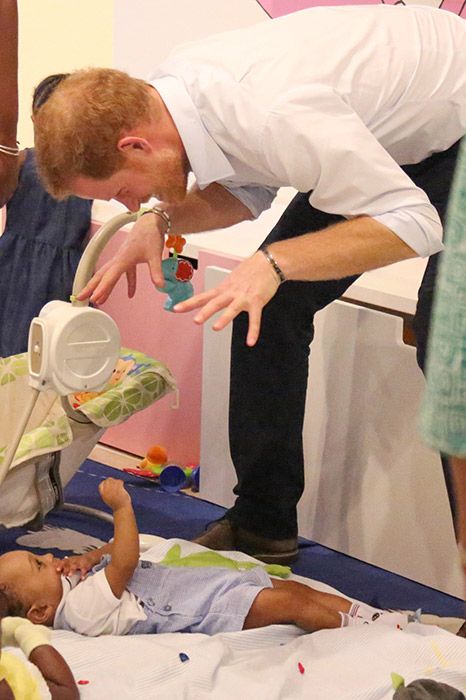 prince harry playing with baby