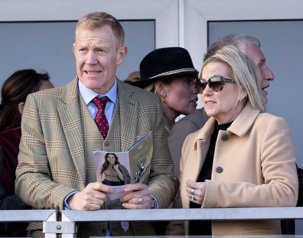 TV Presenter Adam Henson in a tweed suit with his wife in a cream jacket and sunglasses