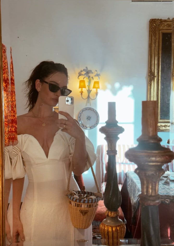 Lily James wearing white Cult Gaia dress and Prada wicker bag for her latest off-duty look