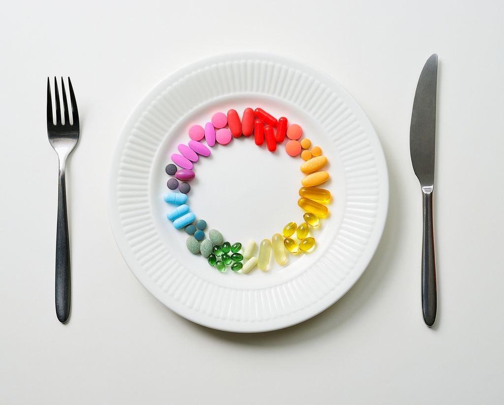 Colour wheel of pills on a white plate