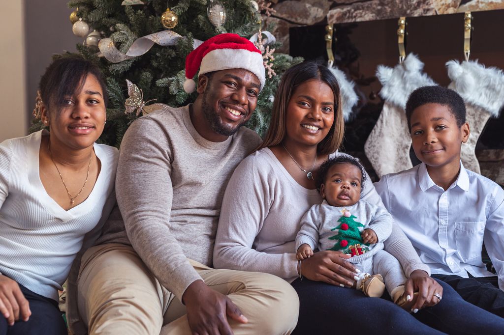 christmas couple with older children and new baby.
