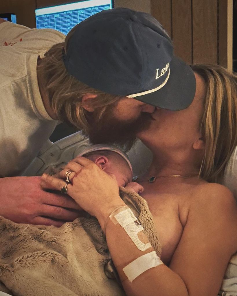 Wyatt Russell kisses wife Meredith Hagner as she hold their son immediately after his birth