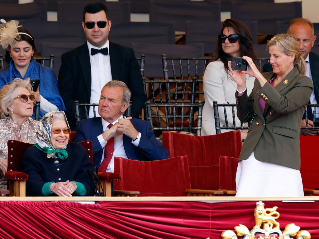 Duchess Sophie taking photos of Lady  at the Windsor Horse Trials as Queen Elizabeth II watches on