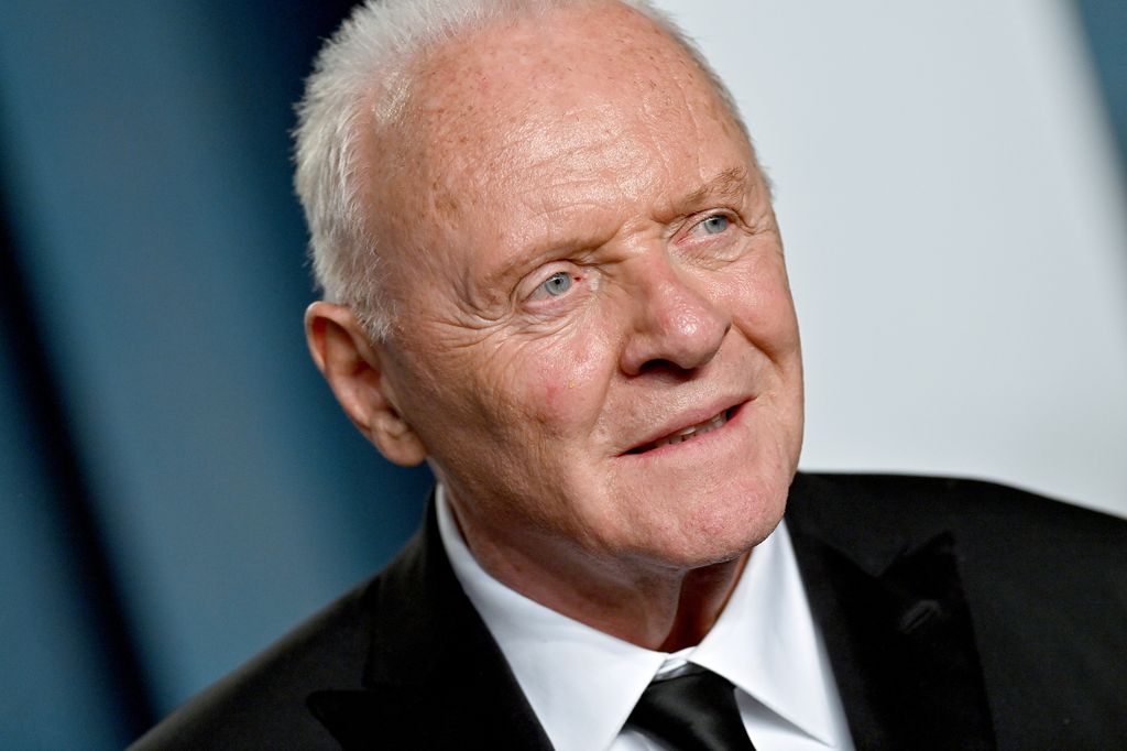 Anthony Hopkins pictured in a suit and tie at the Oscars looking towards photographers