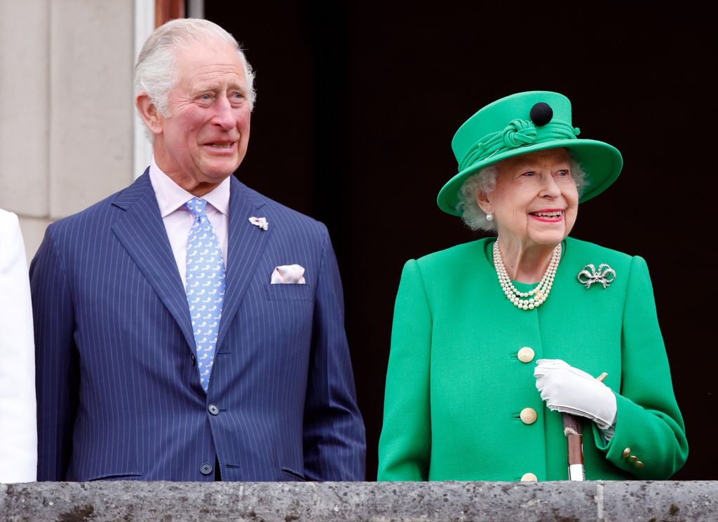 Prince Charles, Prince of Wales and Queen Elizabeth II stand on the balcony of Buckingham Palace following the Platinum Pageant on June 5, 2022 in London, England.