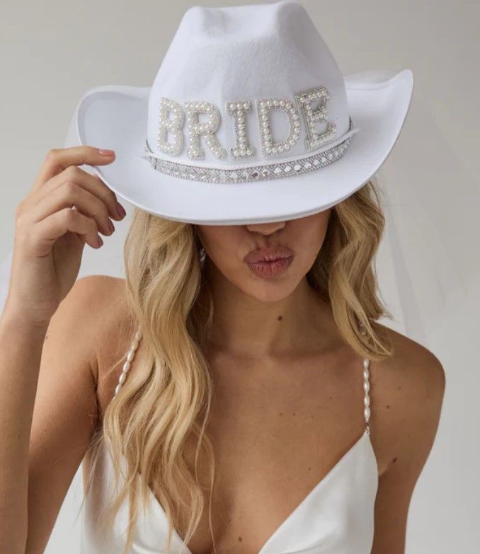 Model wearing white bejewelled cowboy hat from Six Stories